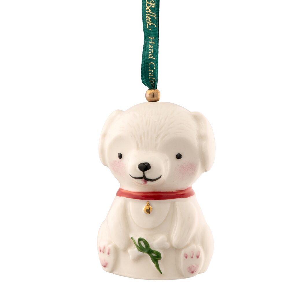 A white bear ornament with green ribbon hanging from it's neck.