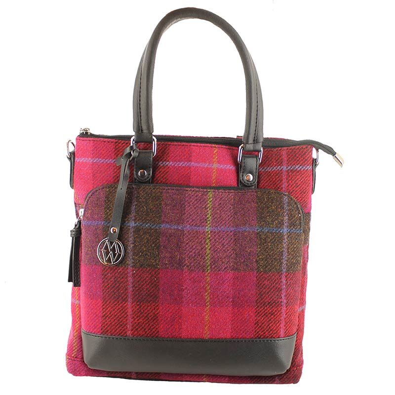 A red plaid bag with brown leather handles.