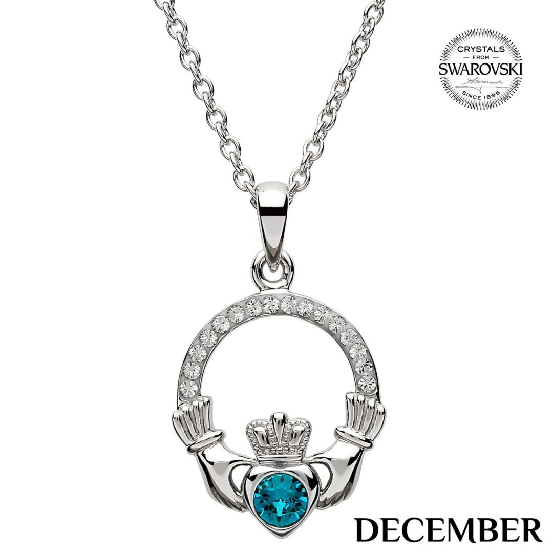 A claddagh necklace with a blue stone in the center.