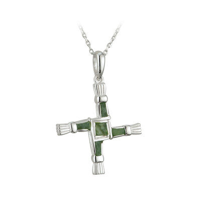 A cross shaped pendant with green stones on it.