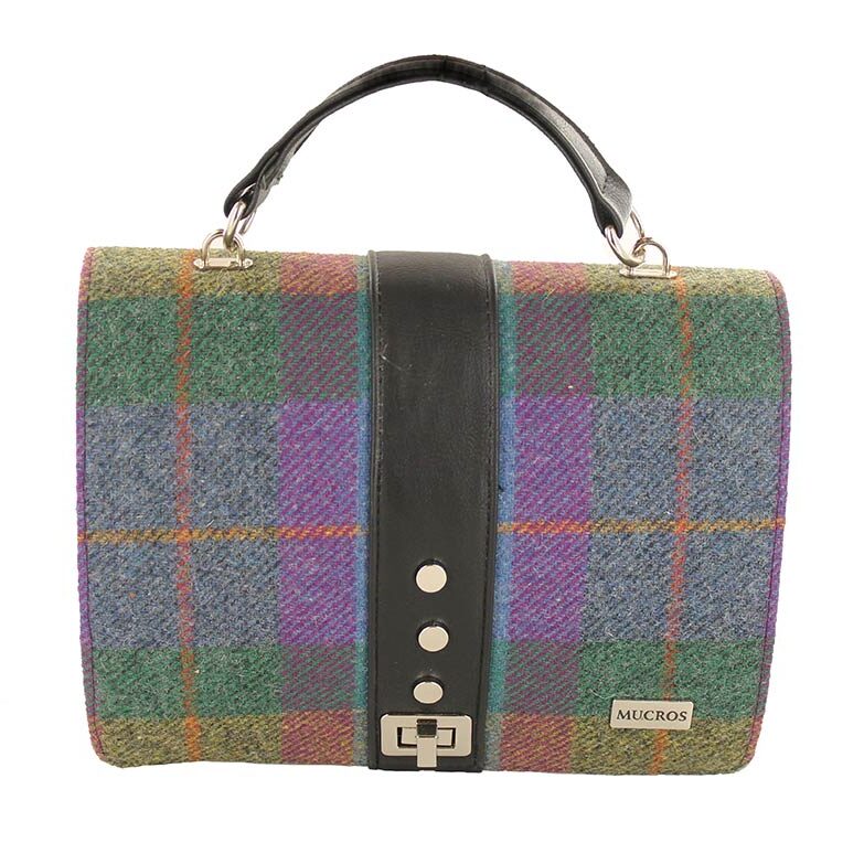 A bag that is very colorful and has some leather straps.