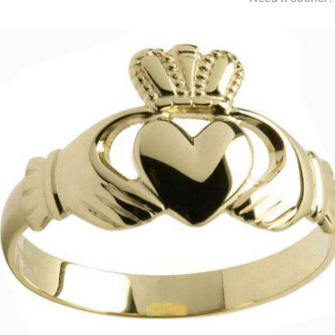 A gold claddagh ring with the heart on it.
