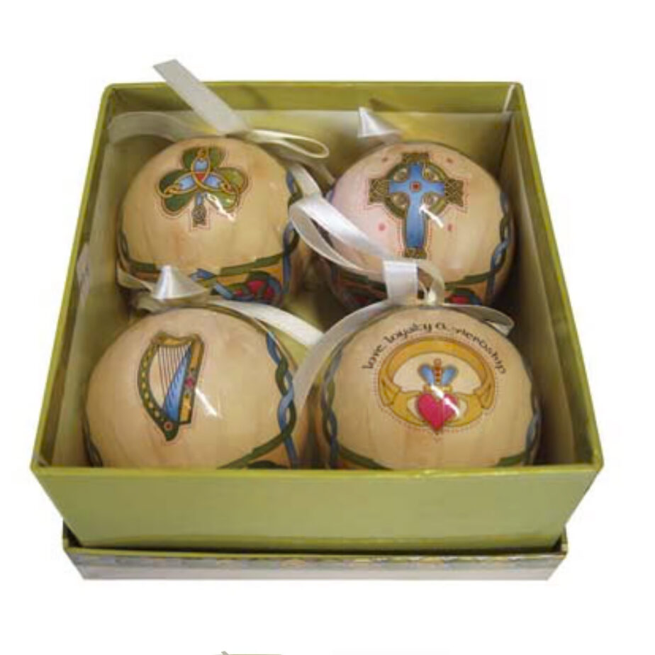 A box of four ornaments with different designs.