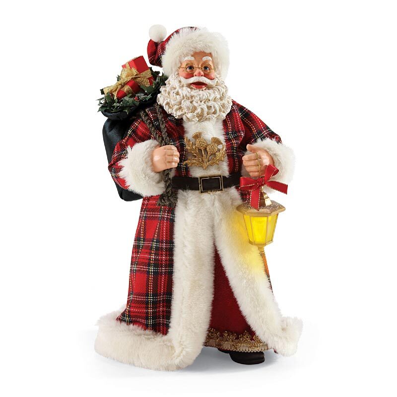A santa claus doll with a bag of christmas presents.