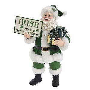 A green and white santa holding a sign.