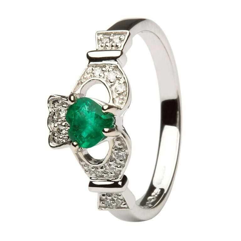 A claddagh ring with an emerald stone on it's side.