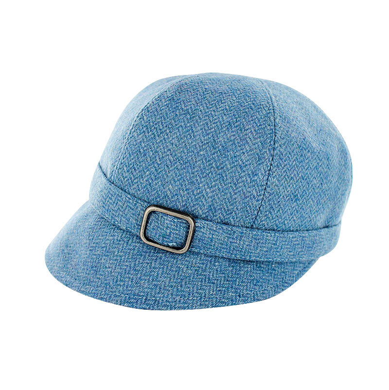 A blue hat with a buckle on top of it.