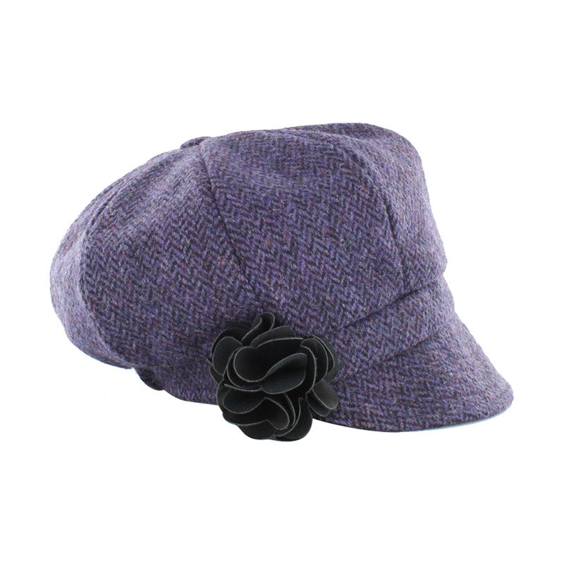A purple hat with a flower on it's side.