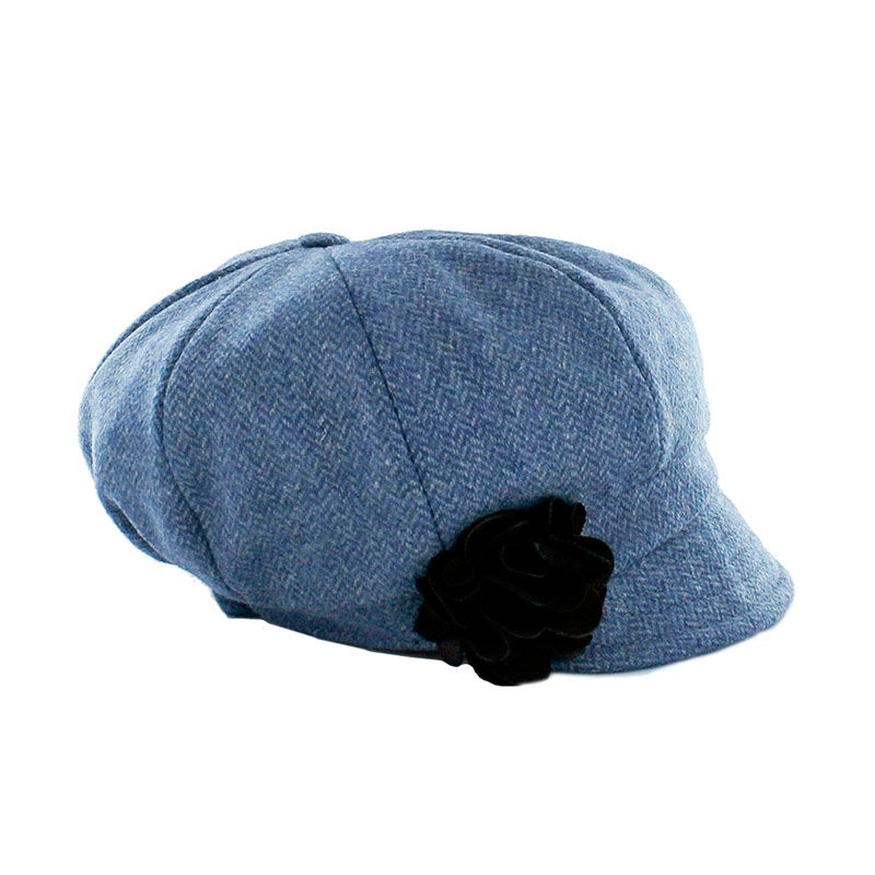 A blue hat with a black flower on it.