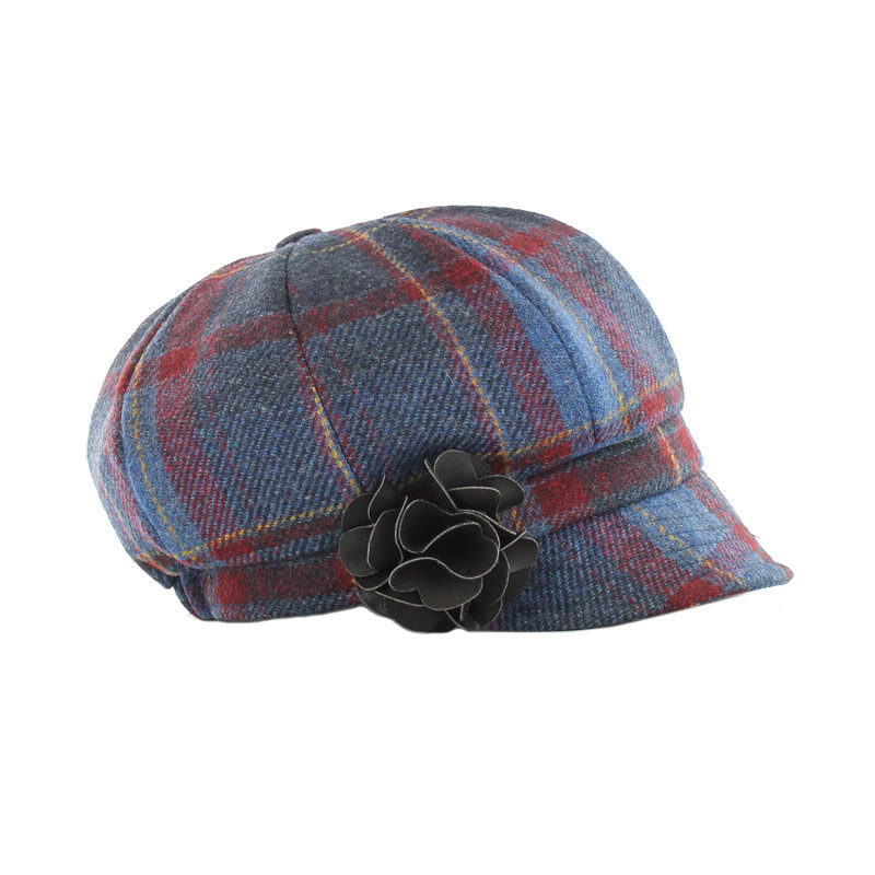 A blue and red plaid hat with a flower on it.