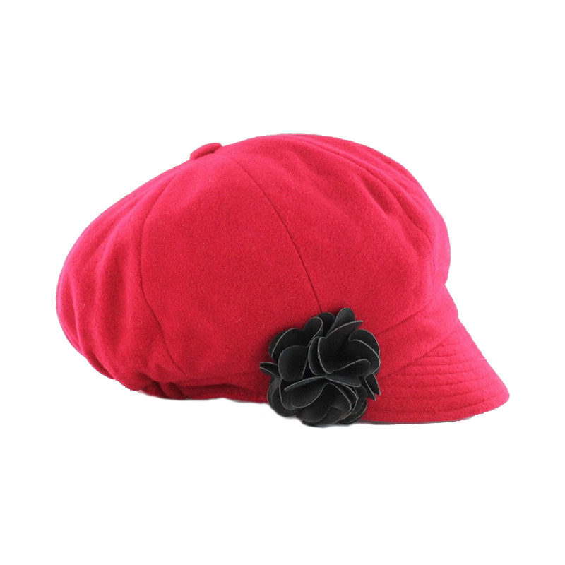 A red hat with black flower on top of it.