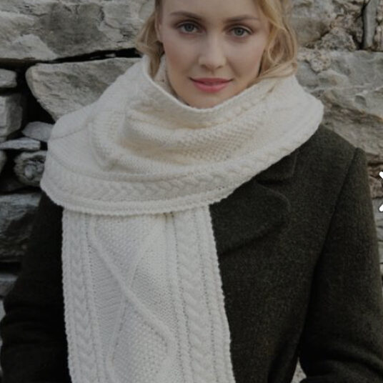 A woman wearing a white scarf and jacket.