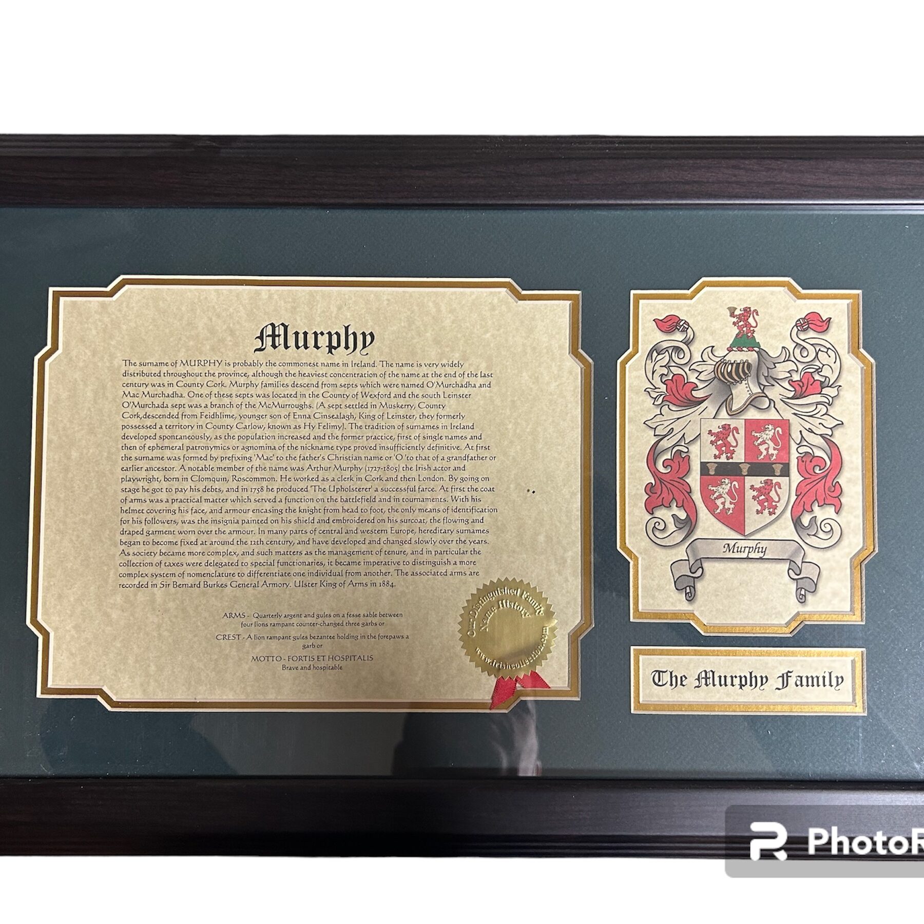 A framed picture of the family crest and a certificate.