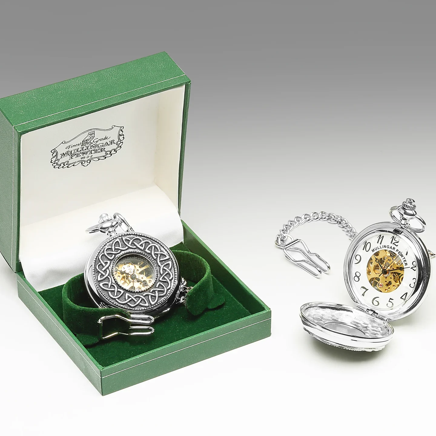 A silver pocket watch with a chain in it's box.