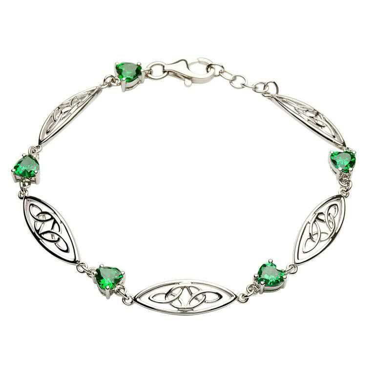 A silver bracelet with green hearts on it.