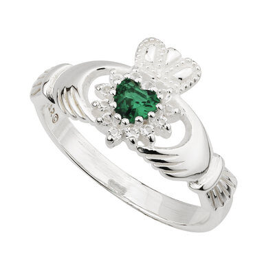 A claddagh ring with a green stone on it.