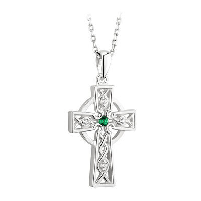 A cross with a green stone on it.