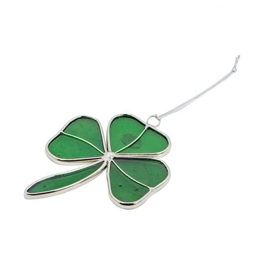A green four leaf clover ornament hanging from a wire.